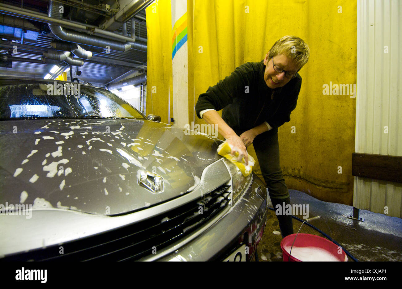 Woman washing her car Stock Photo