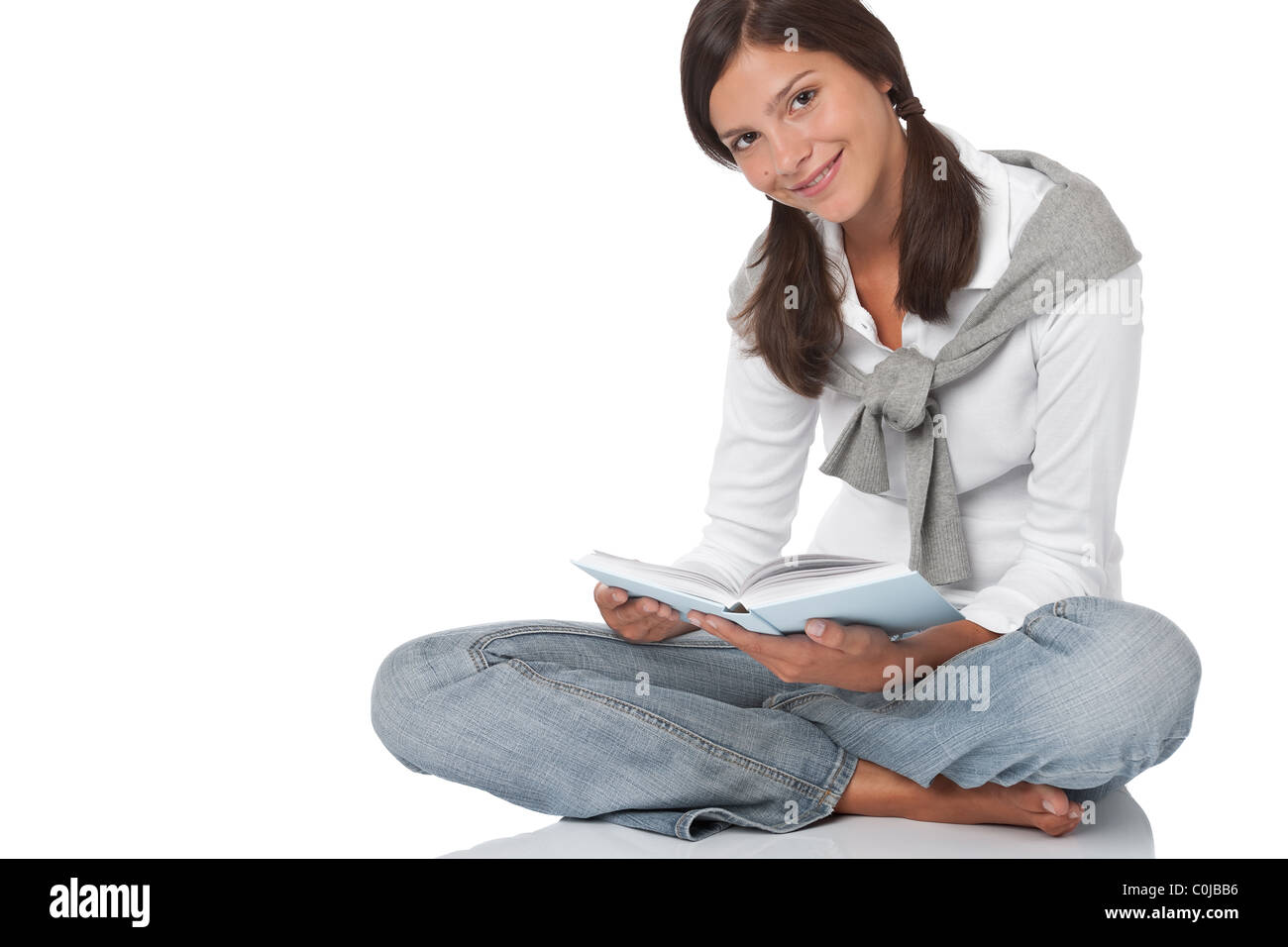Brown hair teenager holding book on white background Stock Photo - Alamy