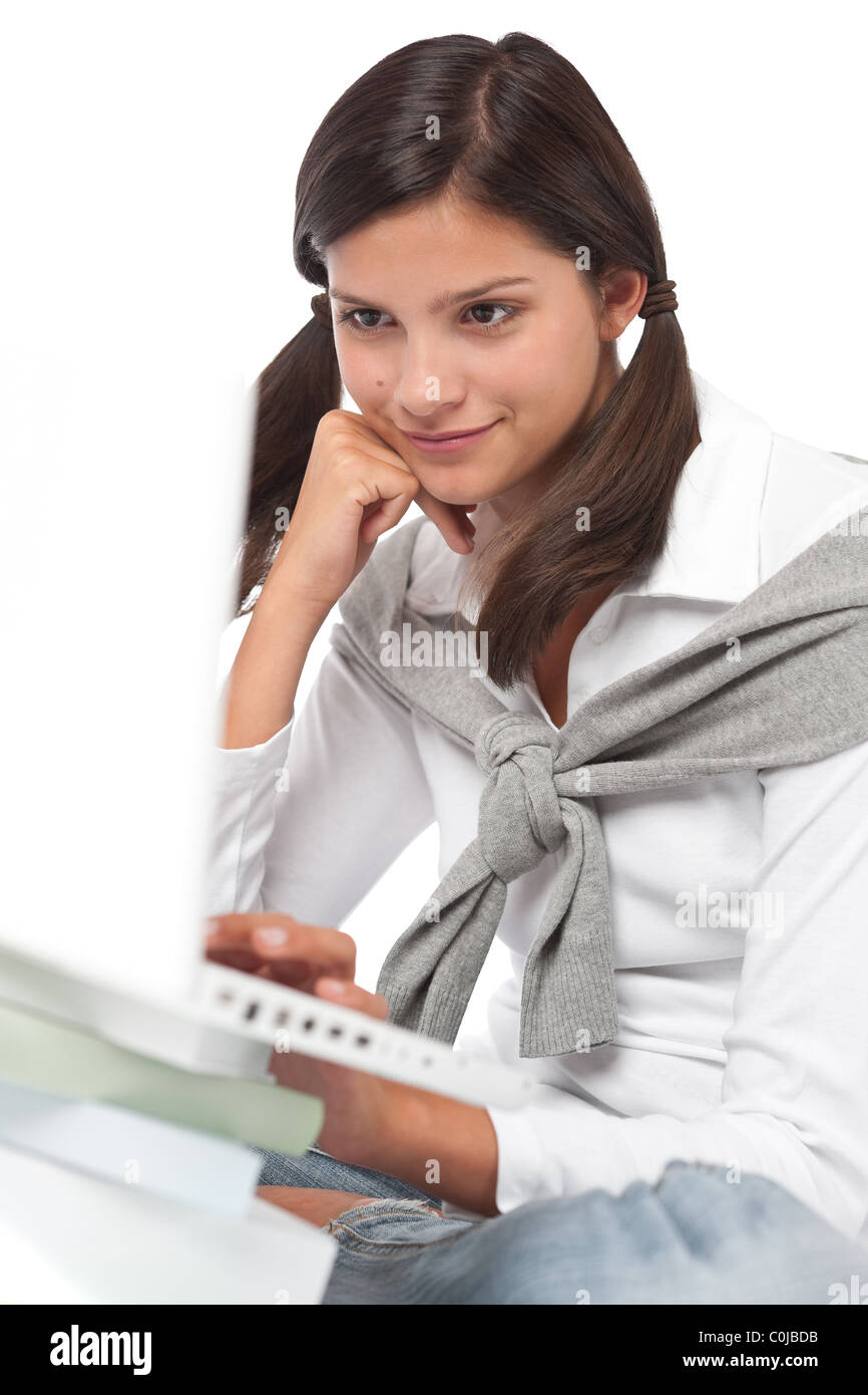 Teenager with books and laptop on white background Stock Photo - Alamy