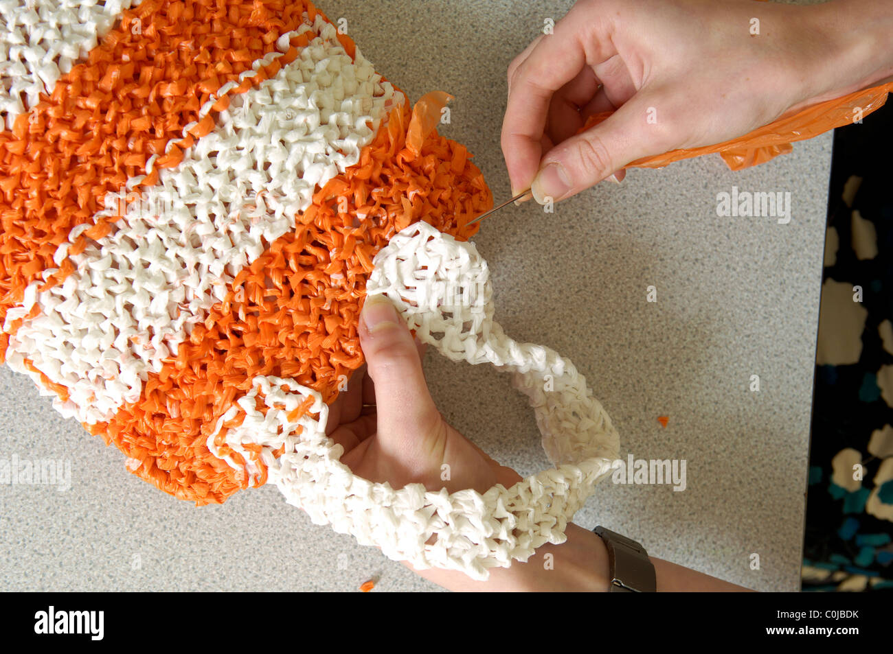 Art Student Elizabeth Edwards knitting together old carrier bags to