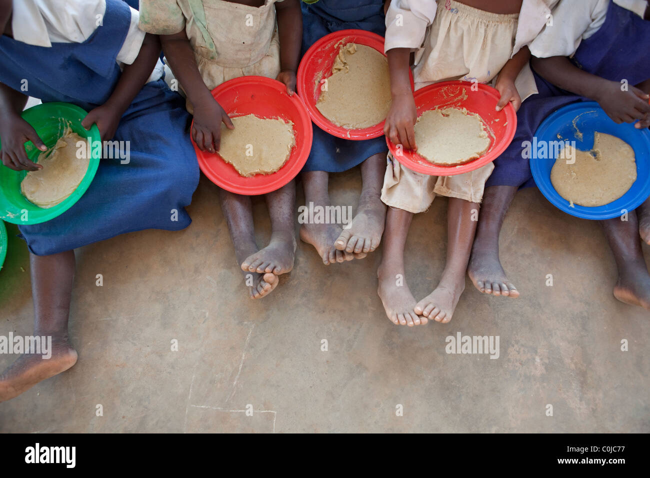 Children eat a meal at a centre for orphans and vulnerable children funded by UNICEF in Mchinzi, Malawi, Southern Africa. Stock Photo