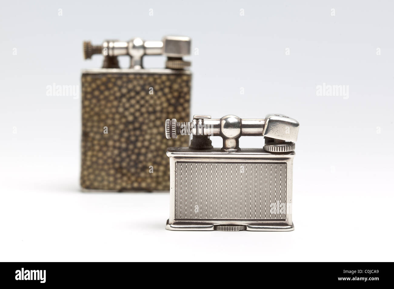 Two antique cigarette lighters made by Dunhill in the Parker Beacon range. (Selective focus) Stock Photo