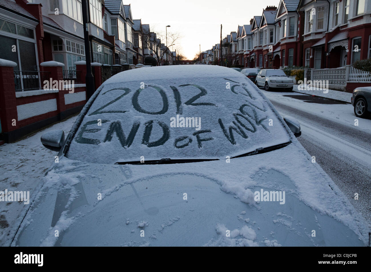 2012 end of the world written on snow-covered car windscreen Stock Photo