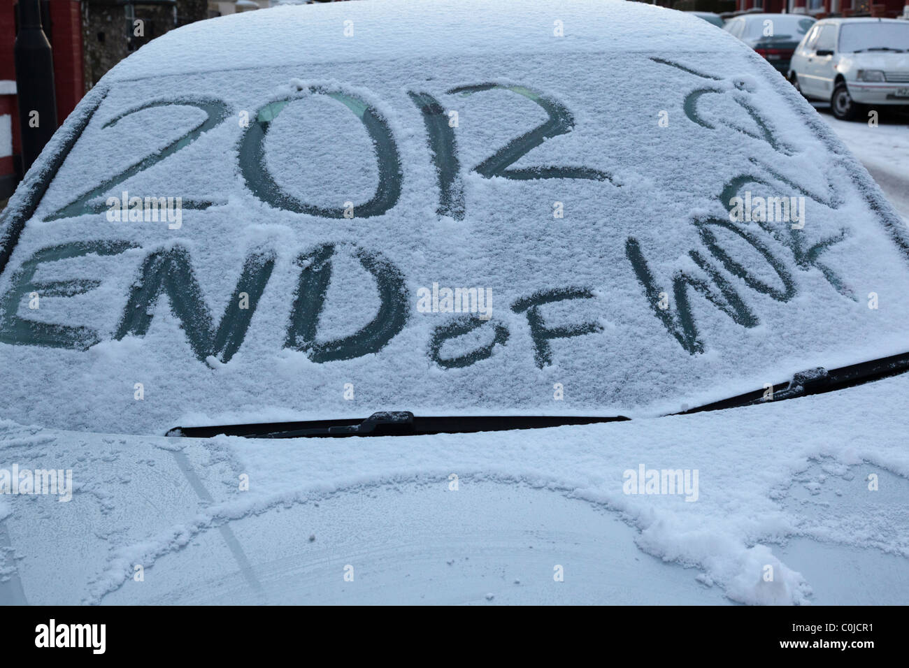 2012 end of the world written on snow-covered car windscreen Stock Photo