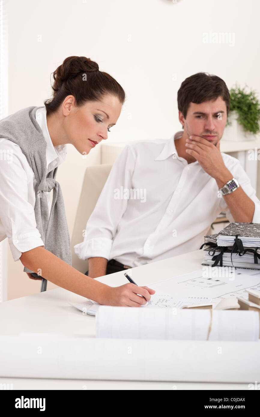 Young man and woman working together at the office Stock Photo - Alamy