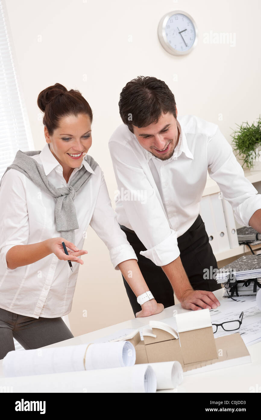 Young man and woman working together at the office Stock Photo - Alamy