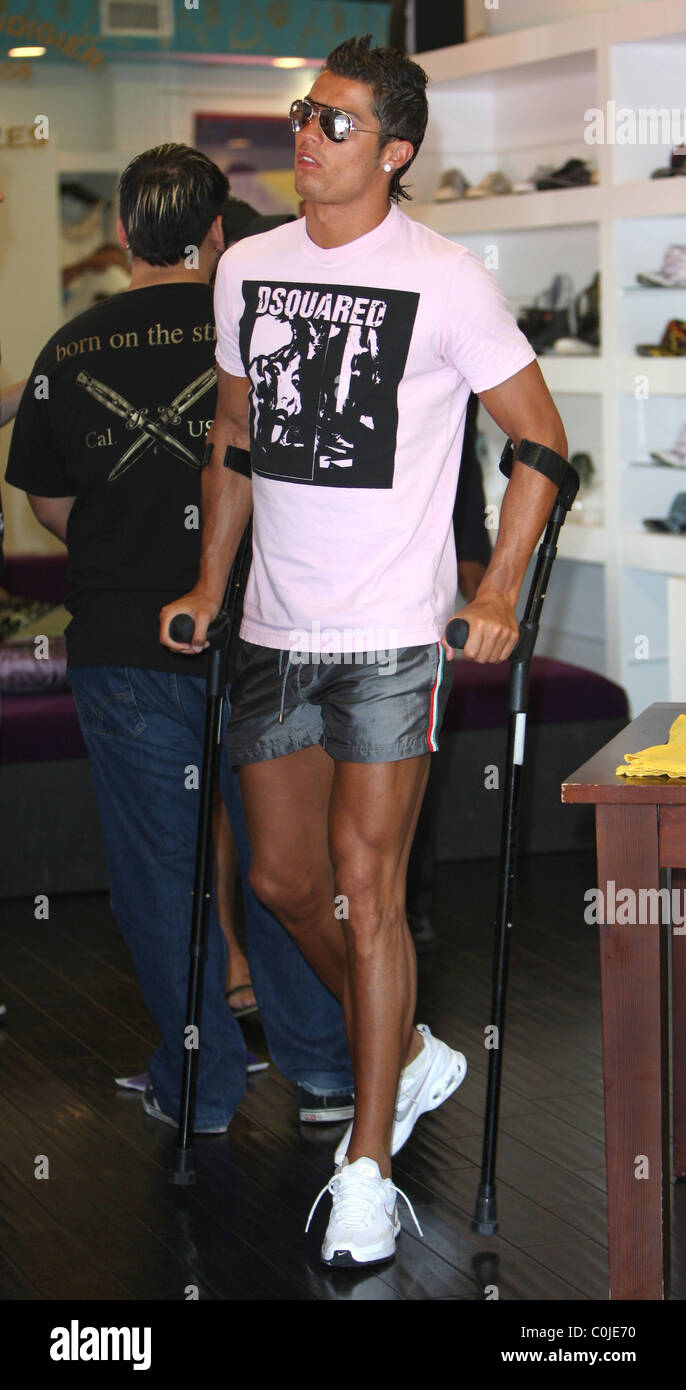 Cristiano Ronaldo shopping on crutches at Christian Audiger store. He  shopped for over an hour and half with help from fellow Stock Photo - Alamy