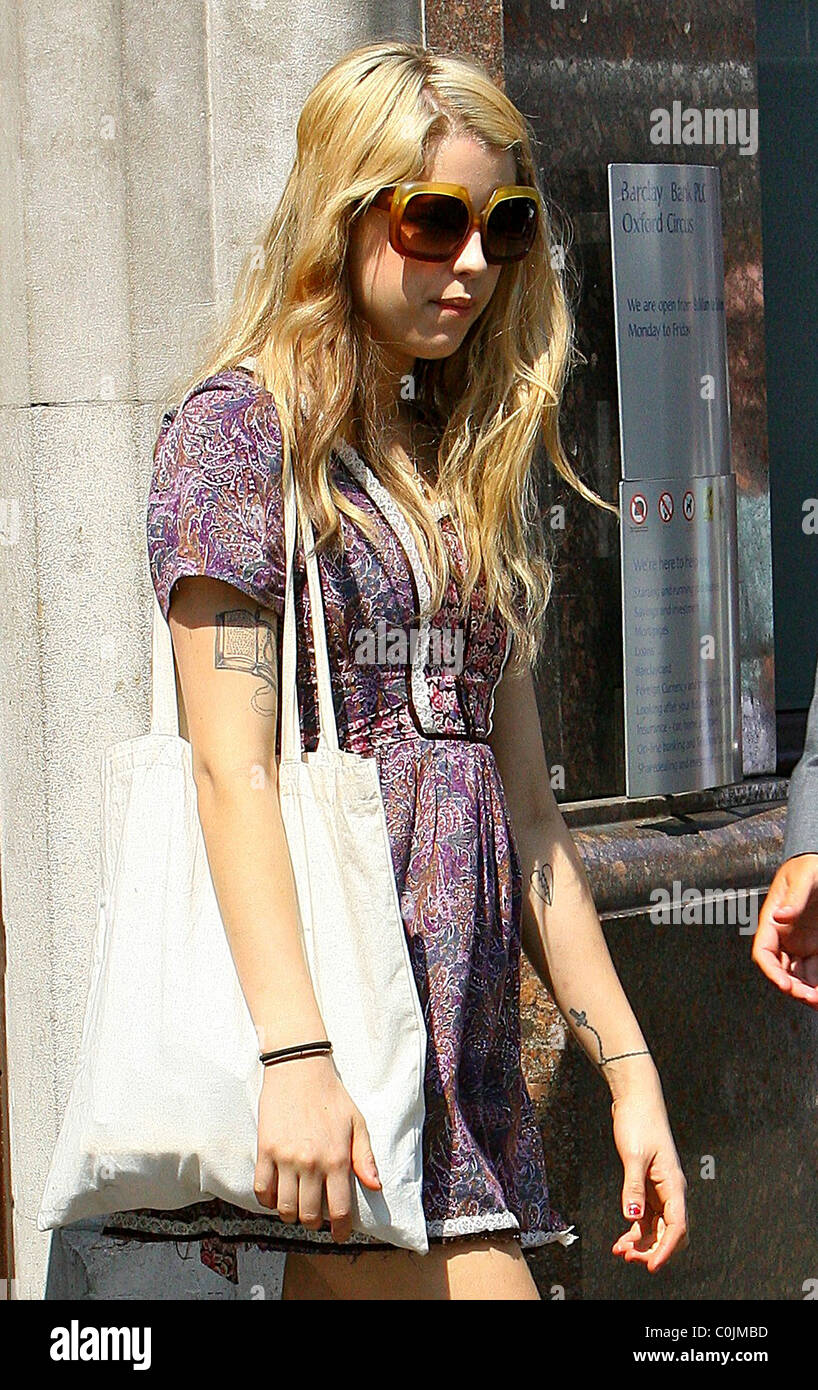 Peaches Geldof leaves a bank in London with a female friend in summer