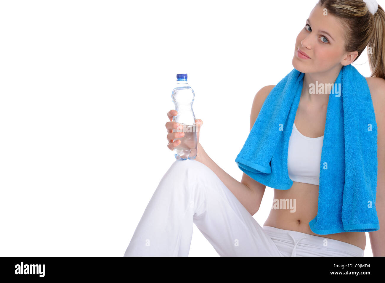 Fitness - Young sportive woman with water and towel on white background ...