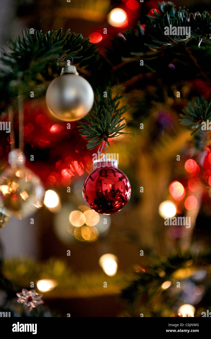Red and gold baubles hanging on a Christmas tree Stock Photo