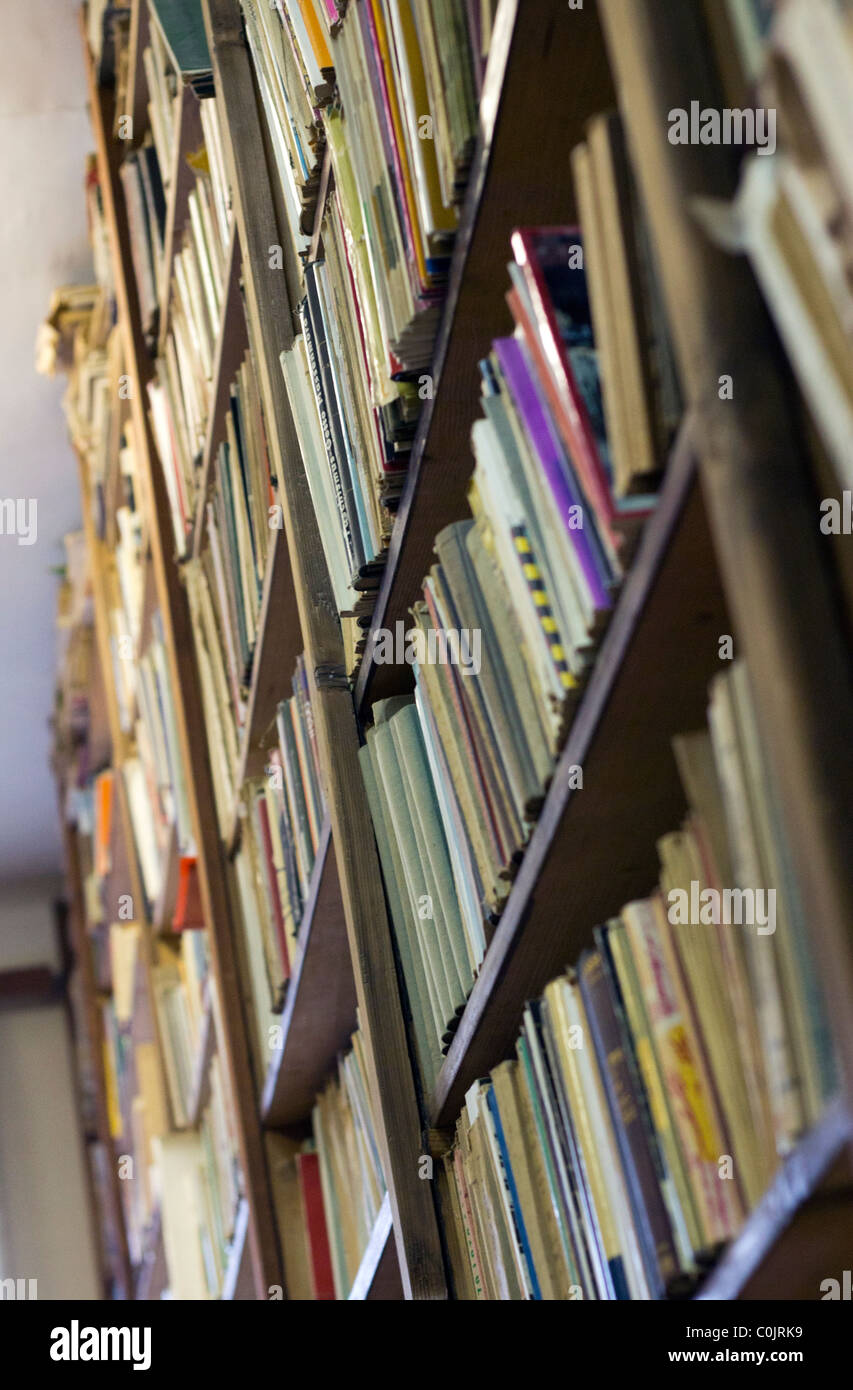 View on the bookshelf in the library with old books. Stock Photo