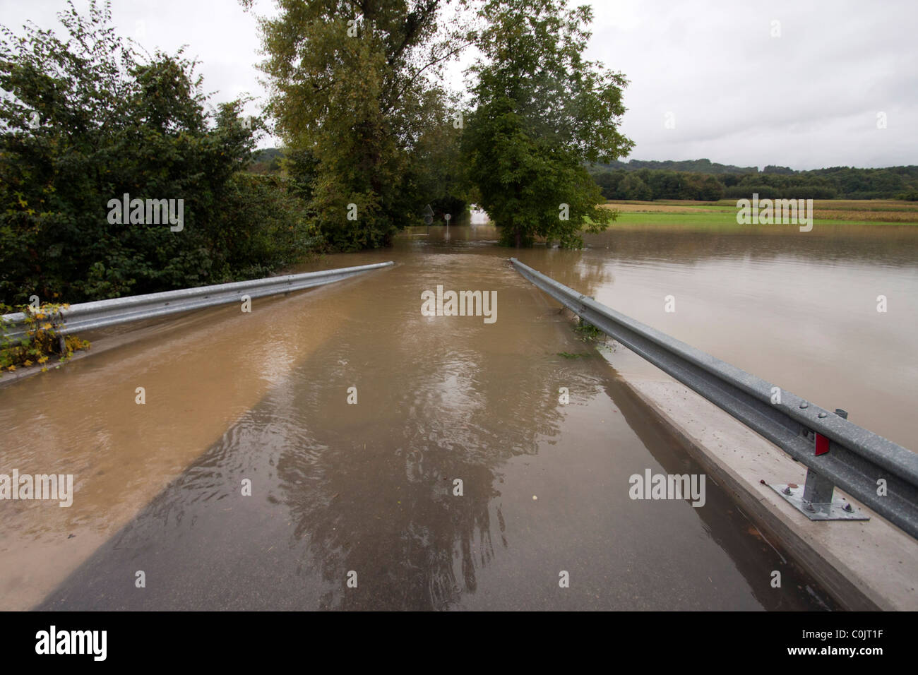 Road under the water in the floods. Stock Photo