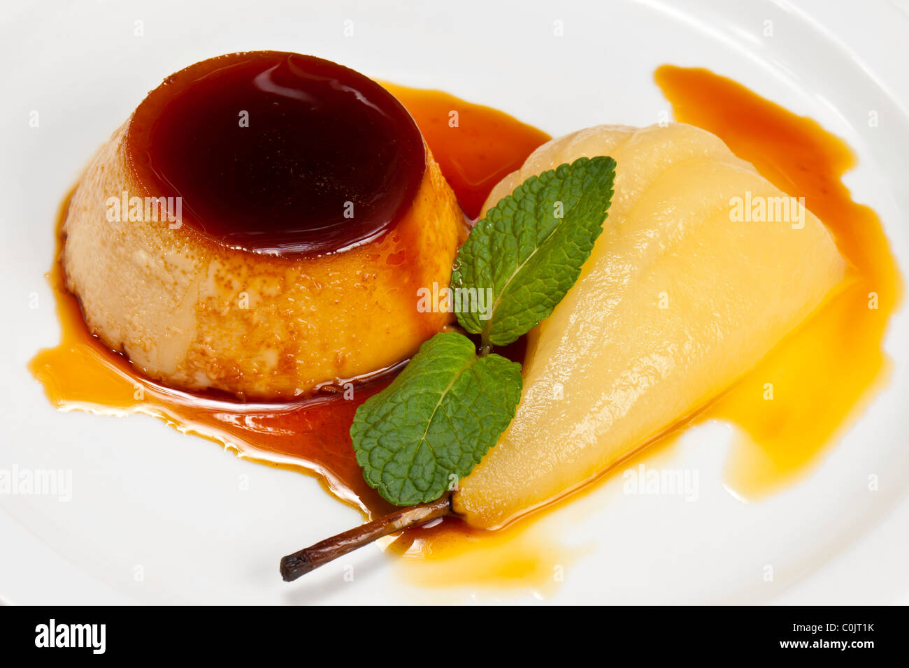 Chef's Presentation dishes - Ginger crème caramel; poached pear. Stock Photo