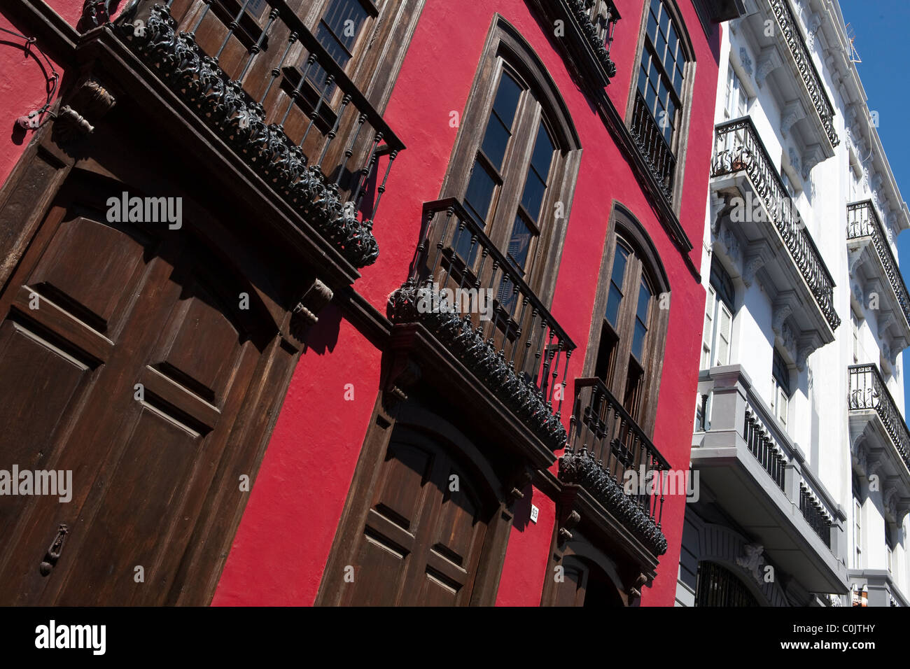 wooden doors red painted balconies Spanish street scene Stock Photo