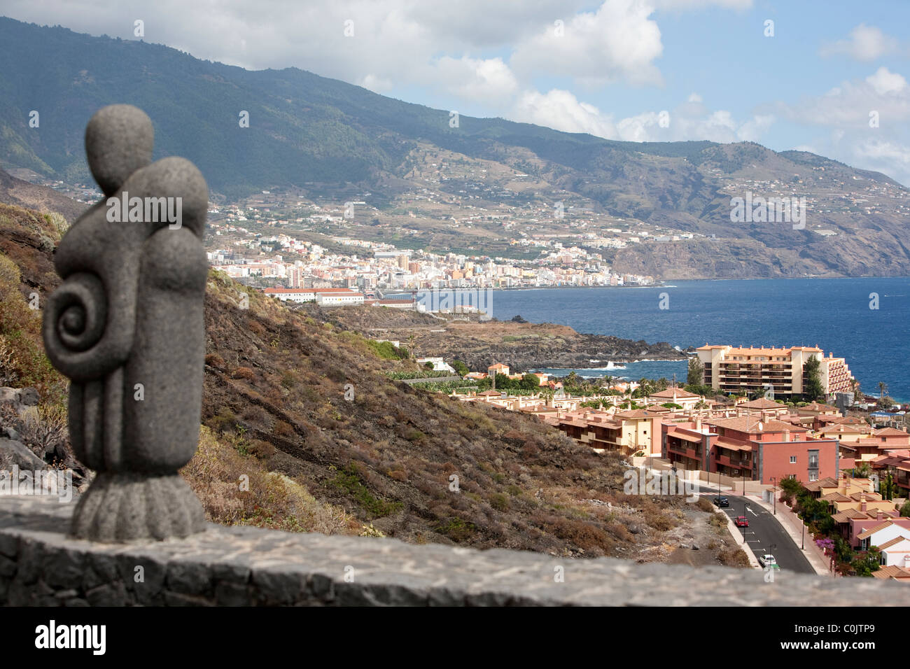 view point towards Santa Cruz de La Palma from Los Cancajos resort La Palma Canary Islands Spain with rock sculpture with mountains in background Stock Photo