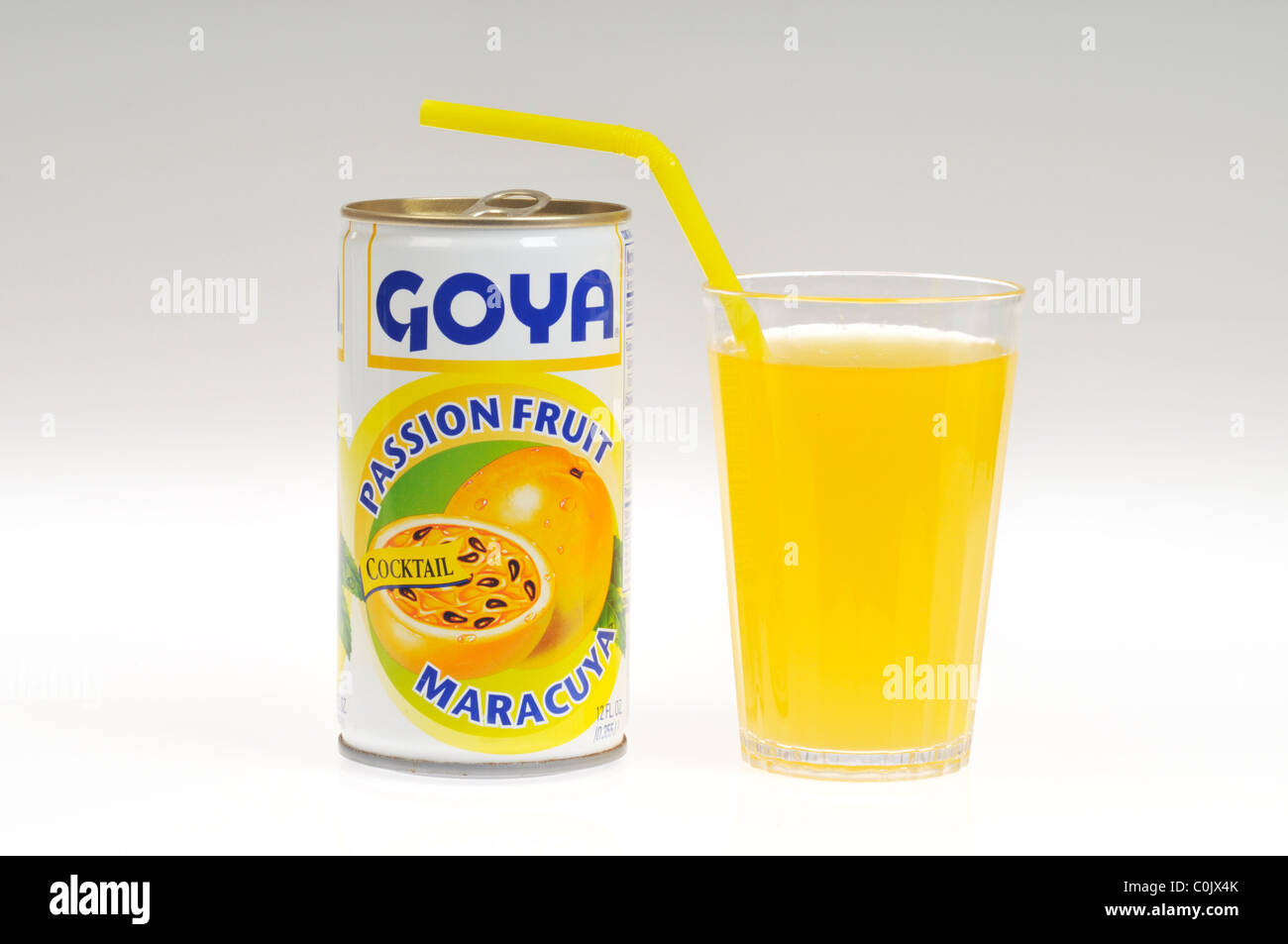 Can of Goya passion fruit cocktail with poured glass with straw on white background, isolated Stock Photo