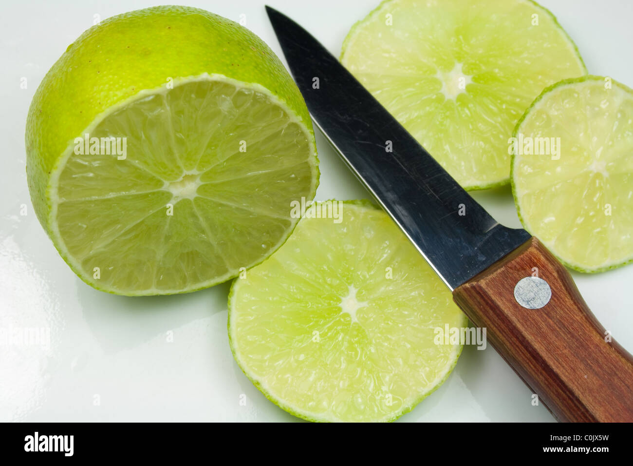 Sliced Lime Fruit and Knife Stock Photo