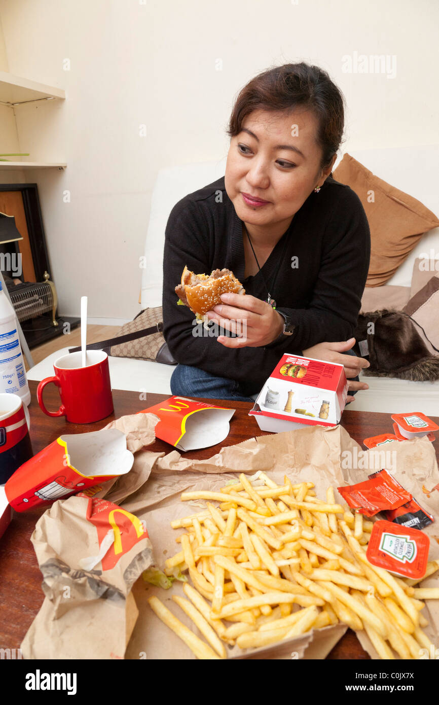 woman eating burger and chips Stock Photo