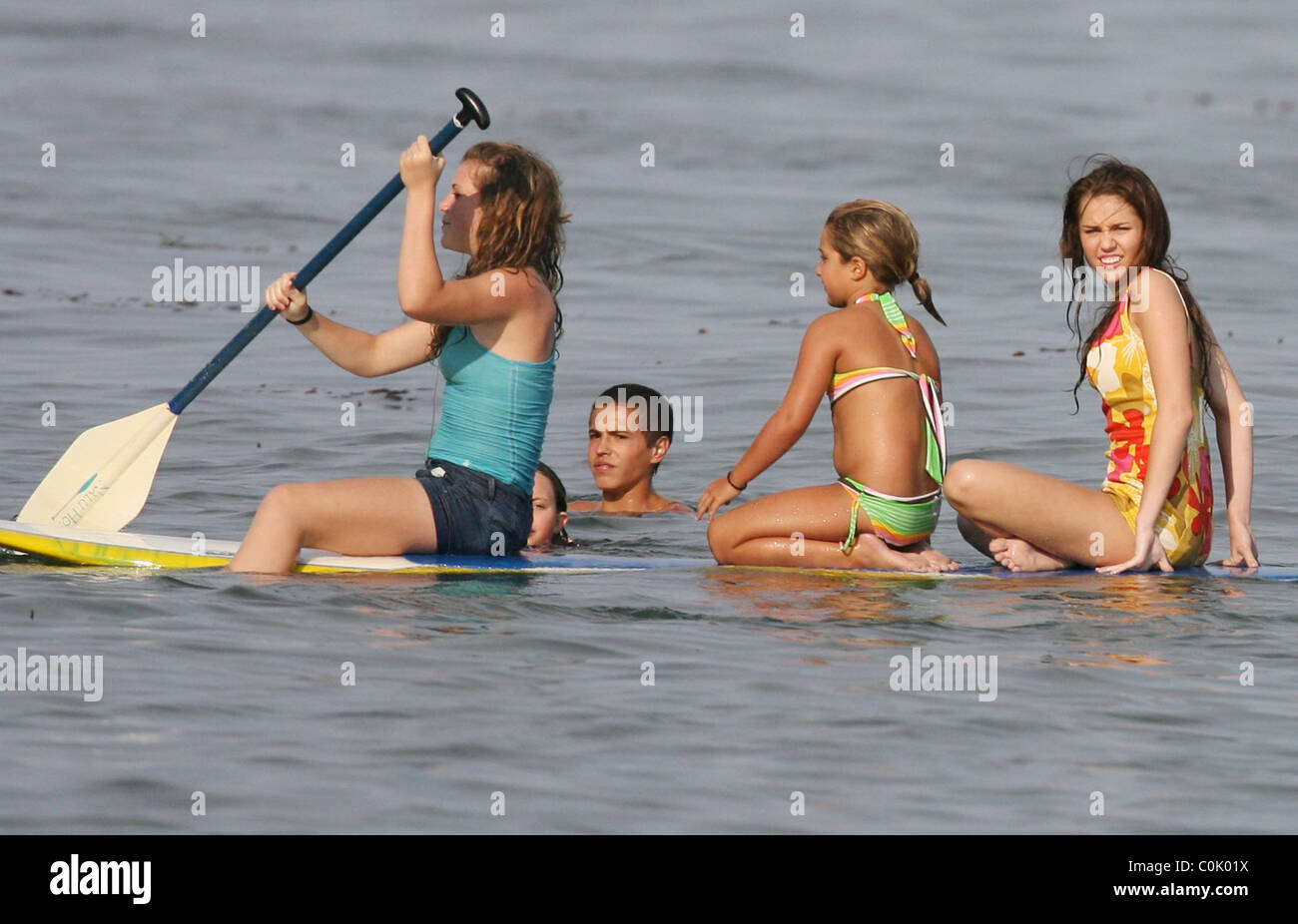 Miley Cyrus relaxes on the beach with a friend while filming the new Hannah  Montana film Los Angeles, California - 11.07.08 Stock Photo - Alamy