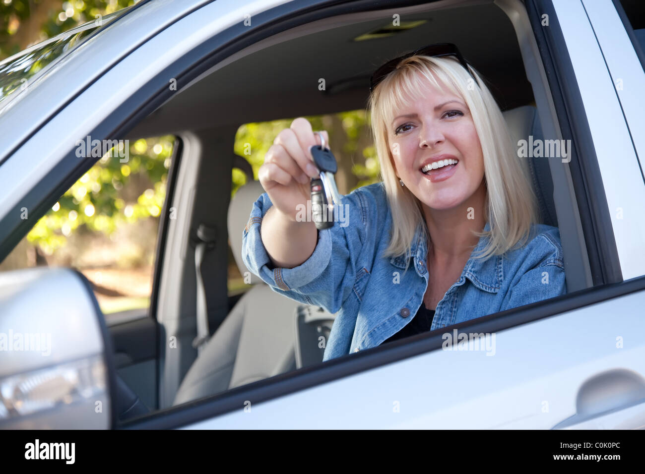 Attractive Happy Woman In New Car with Keys Stock Photo - Alamy