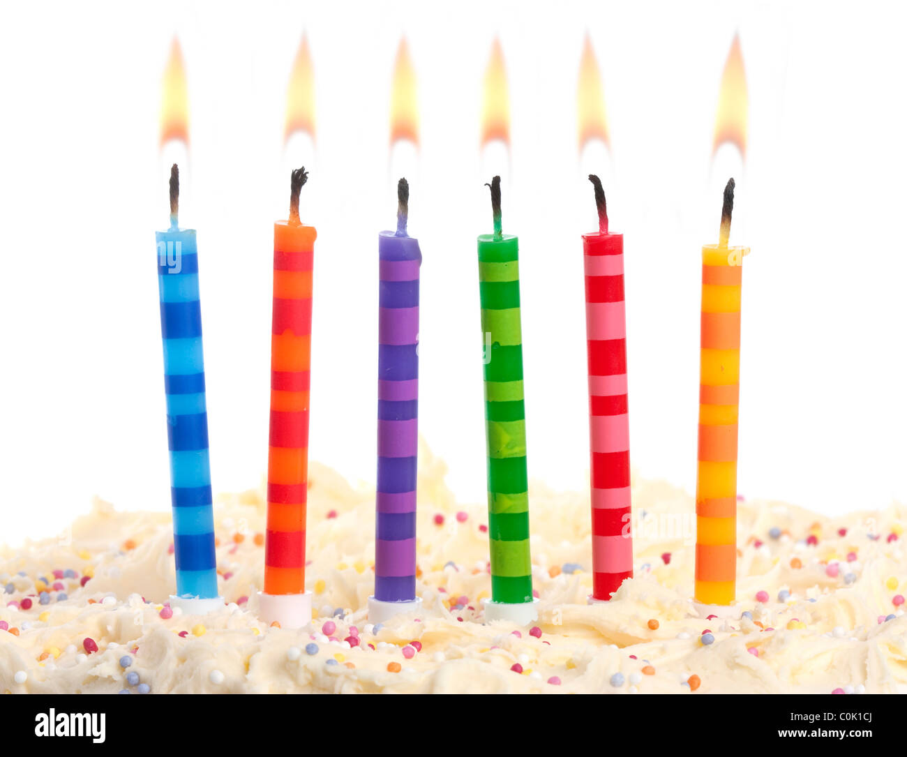 birthday cake with 6 coloured candles on a red background Stock Photo -  Alamy