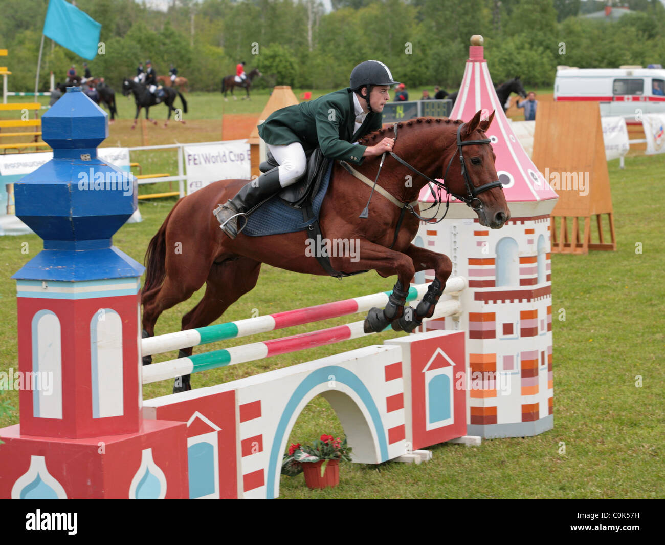 Full Length Shot Young Female Rider Jumping Hurdle Her Horse fotos, imagens  de © PeopleImages.com #585006420