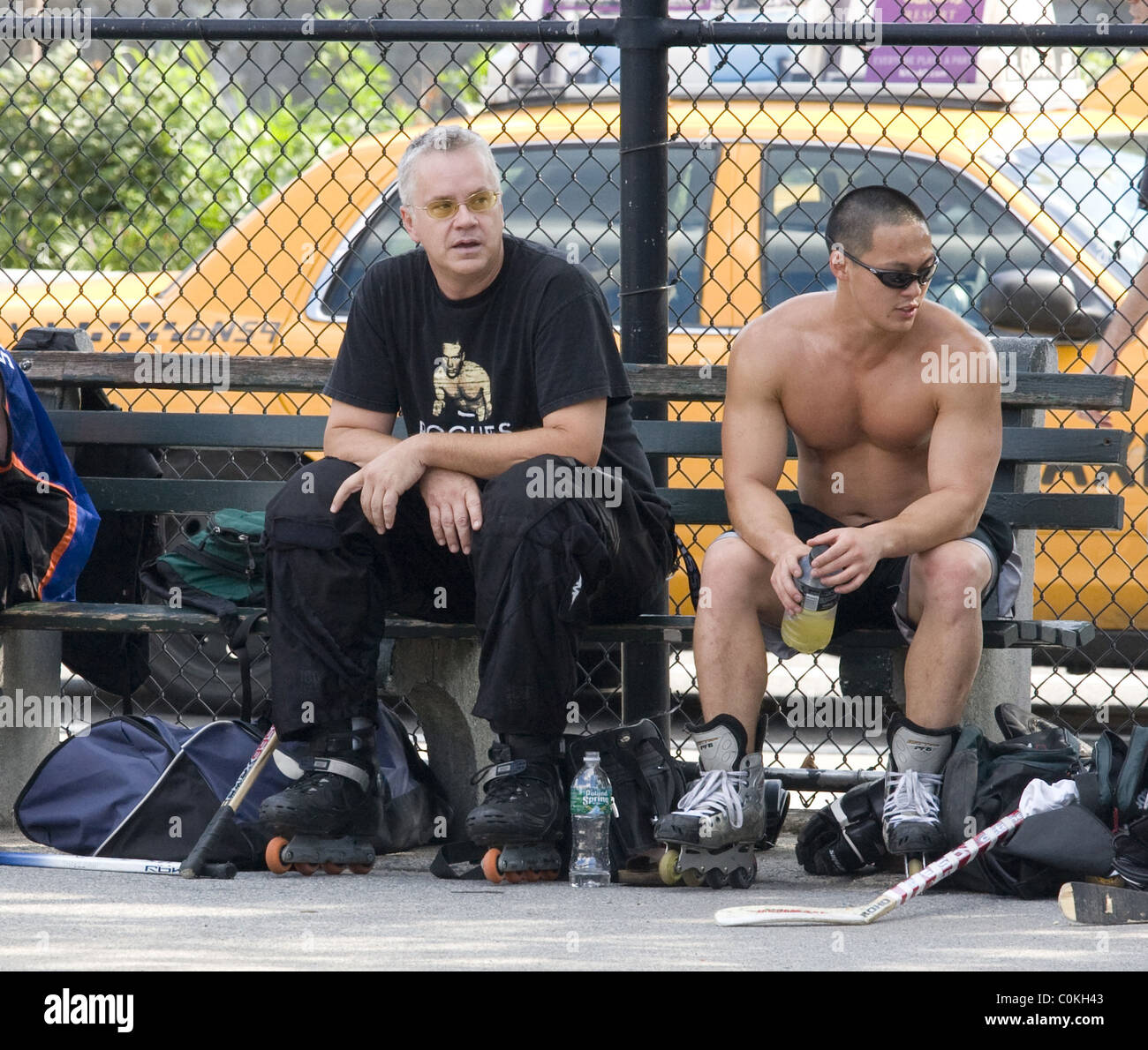 Tim Robbins enjoys a game of roller hockey, stopping to pose for a photograph with fans in