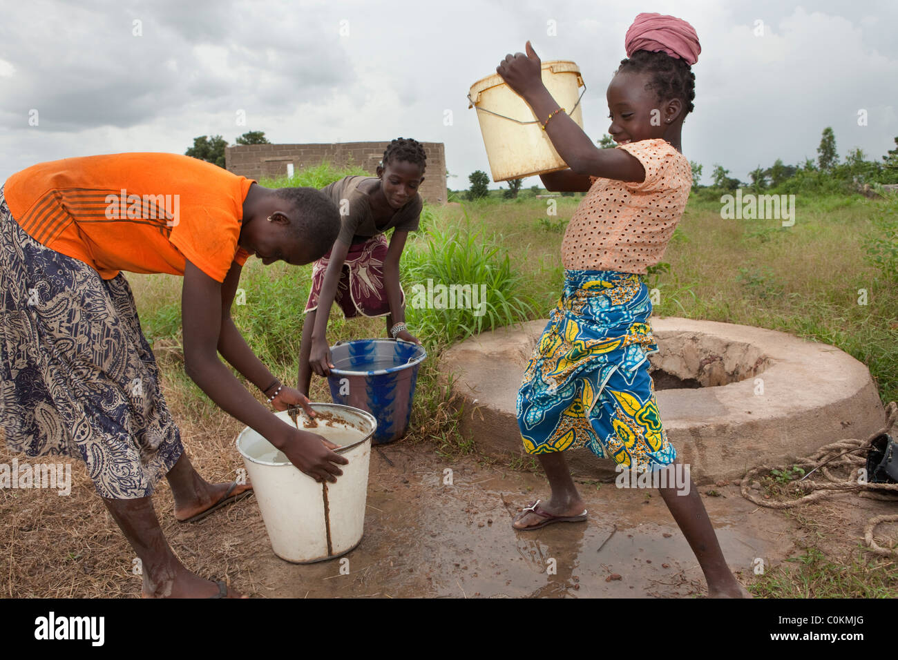 Girls fetch water from a village well in Safo, Mali, West Africa. Stock Photo