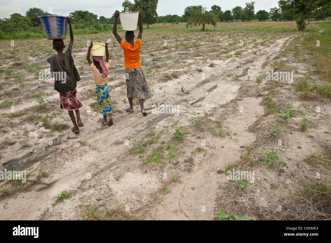 Girls bring water home from a well in Safo, Mali, West Africa. Stock Photo