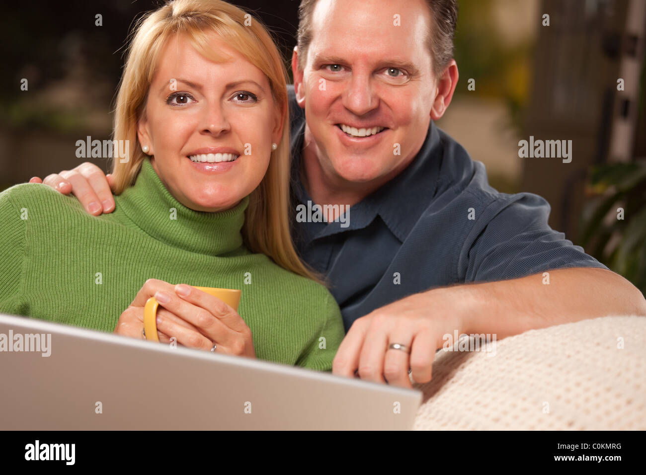 Affectionate Happy Couple Using Their Laptop Together Stock Photo - Alamy