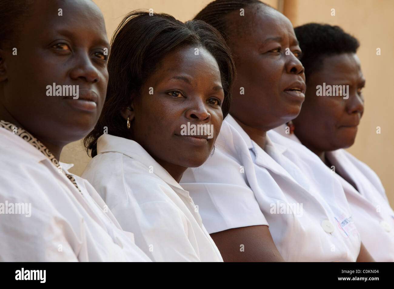 A group of nurses sit outside a clinic in Kampala, Uganda, East Africa. Stock Photo