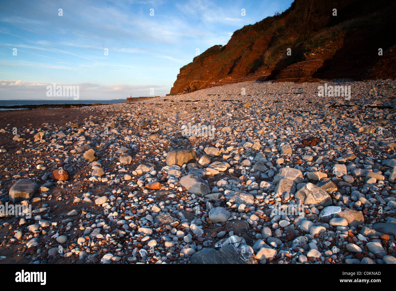 A view along the beach at Watchett, Somerset, UK at sunset Stock Photo