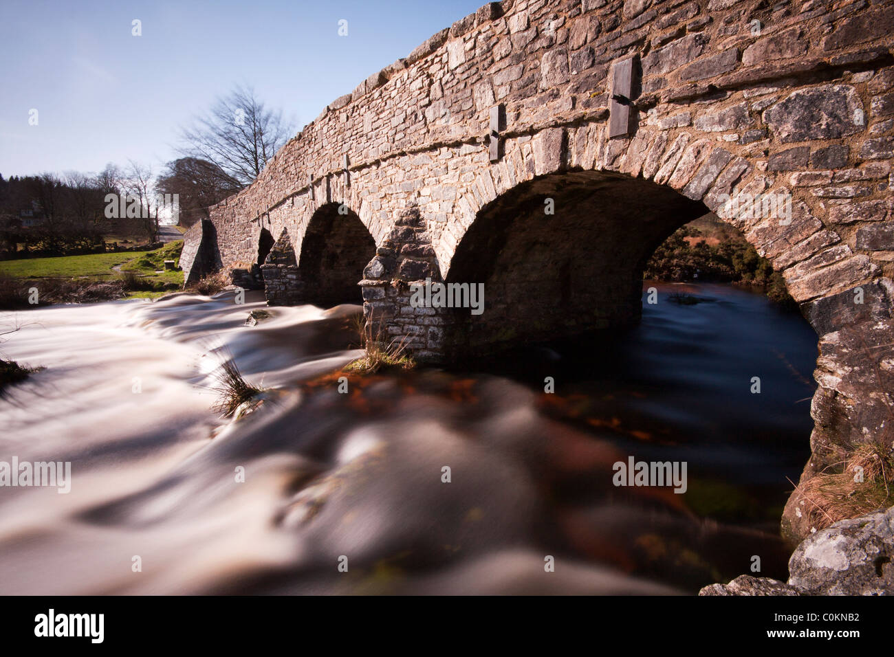 Slow exposure showing the flow of the River Dart under the bridge at Post Bridge, Dartmoor Stock Photo