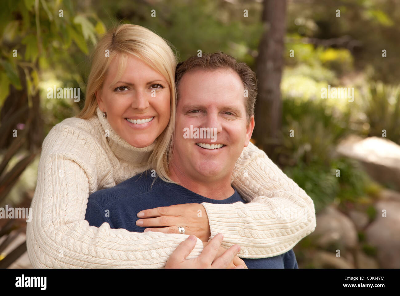 Hugging Couple Portrait in the Park Stock Photo - Alamy