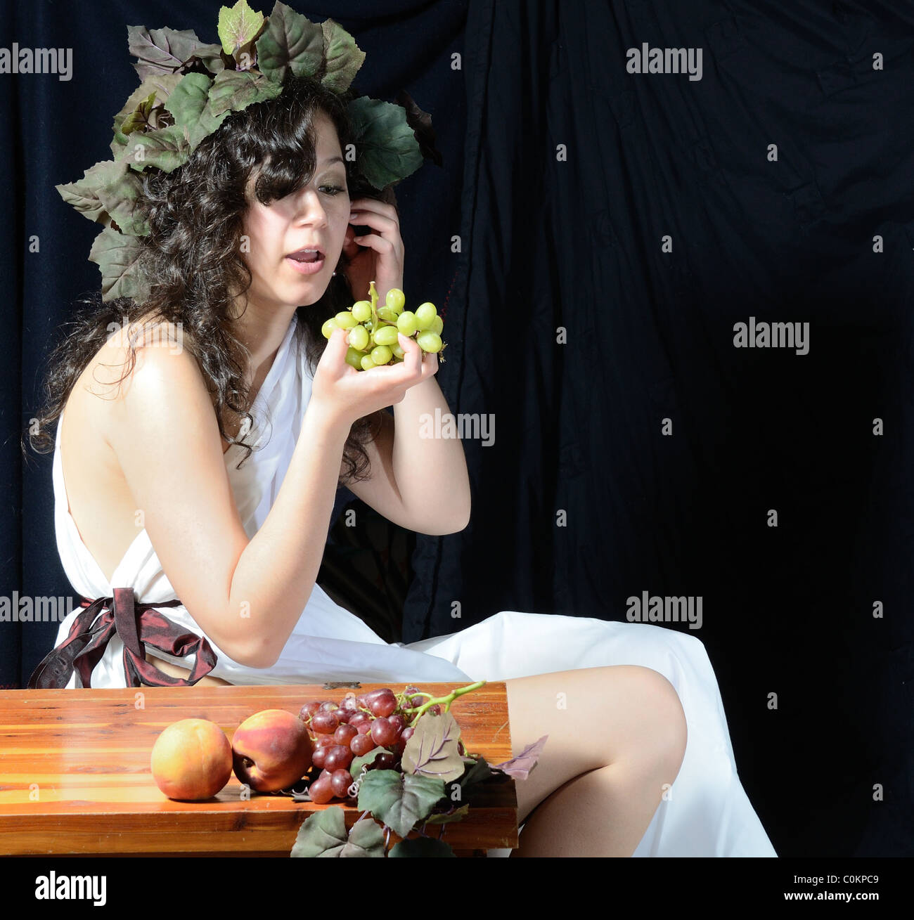A beautiful women dressed as Dionysus the Greek god of the grape harvest. Stock Photo