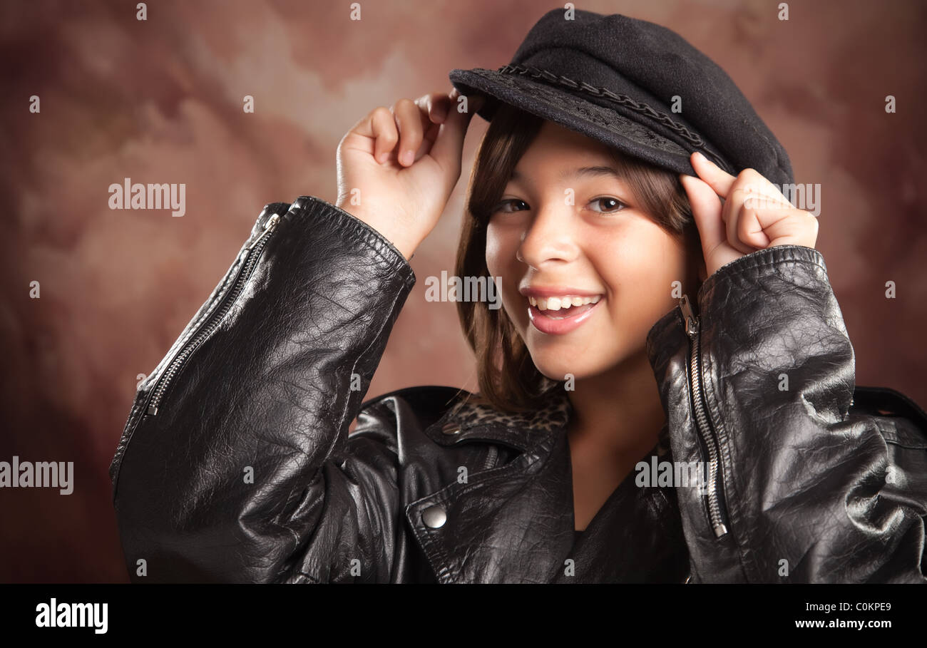 Fun Hispanic Girl with Hat and Leather Jacket Studio Portrait Stock