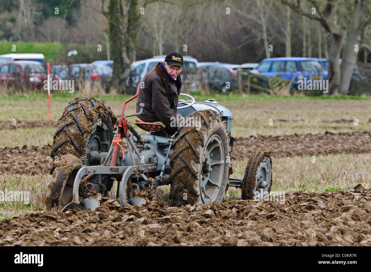 Farmer using a vintage tractor to plough a field Stock Photo - Alamy