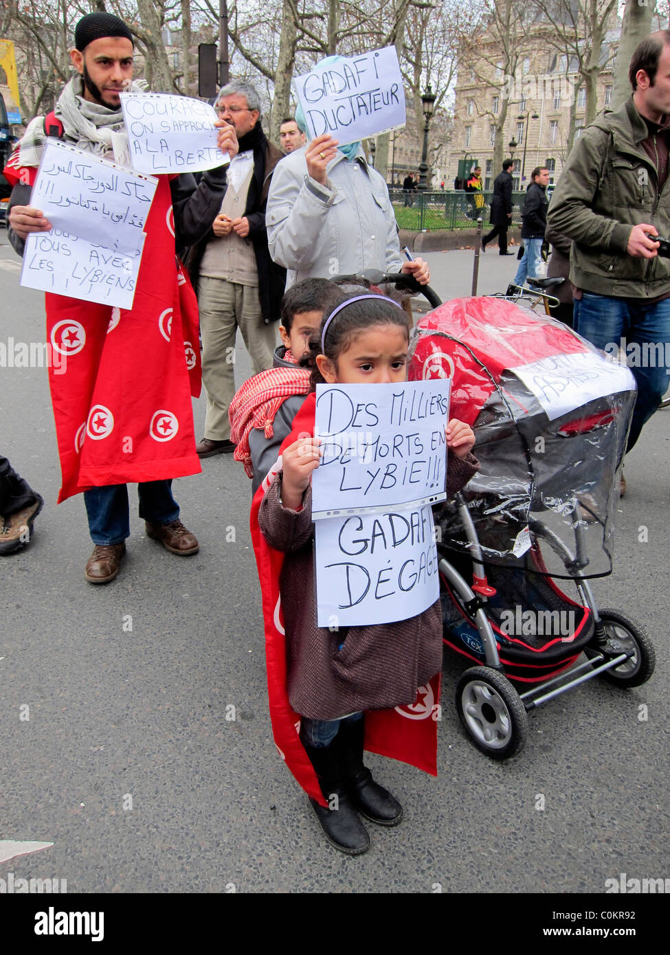 Paris, France, Public Demonstration, in Support of Libyan Revolution, Arabian Migrant Family Children Carrying French Protest Poster, with Young Children "Arab Spring" immigrants Europe Stock Photo