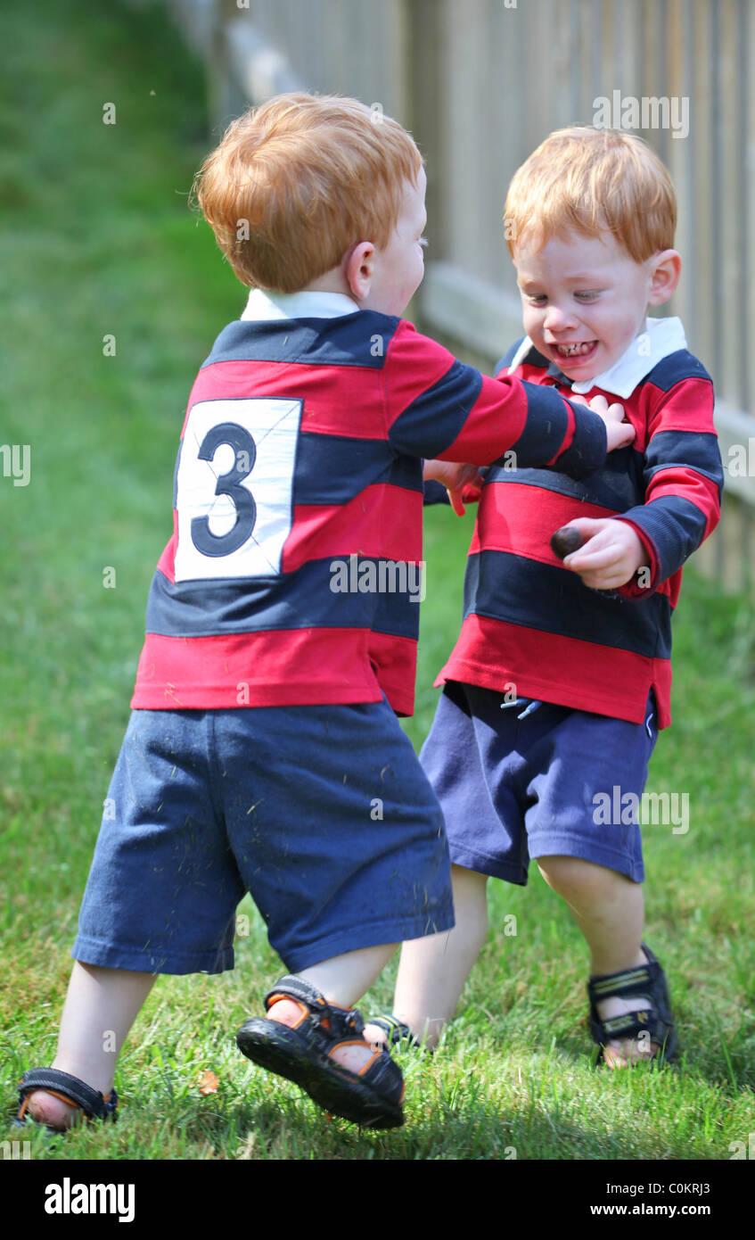 Happy twin boys wearing rugby shirts Stock Photo Alamy