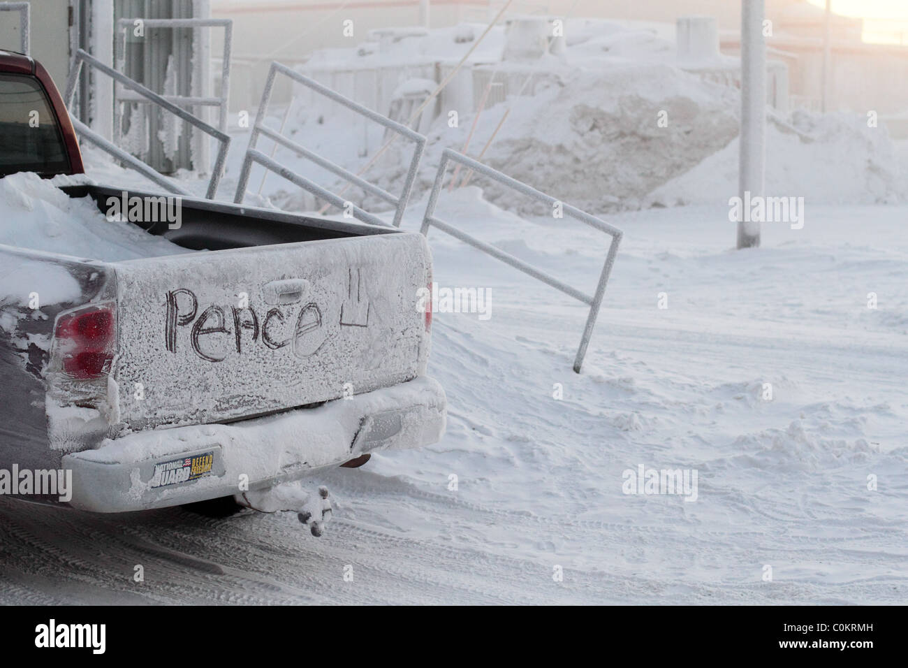 The word peace written across back of pickup tailgate in the ice in Barrow, AK in Arctic Circle with National Guard sticker. Stock Photo