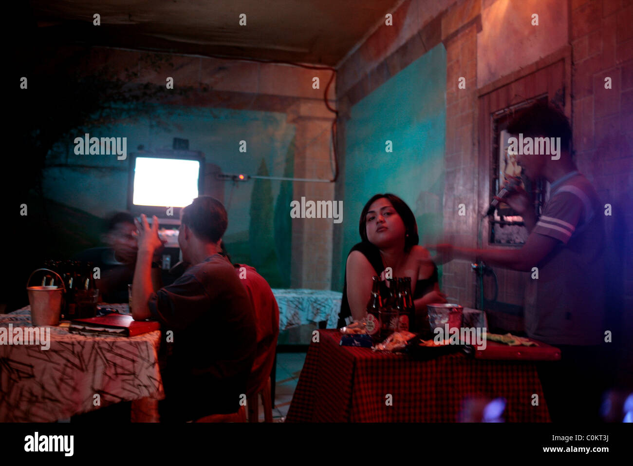 Patrons sing in a karaoke bar in Adriatico Street, Malate, Manila, the