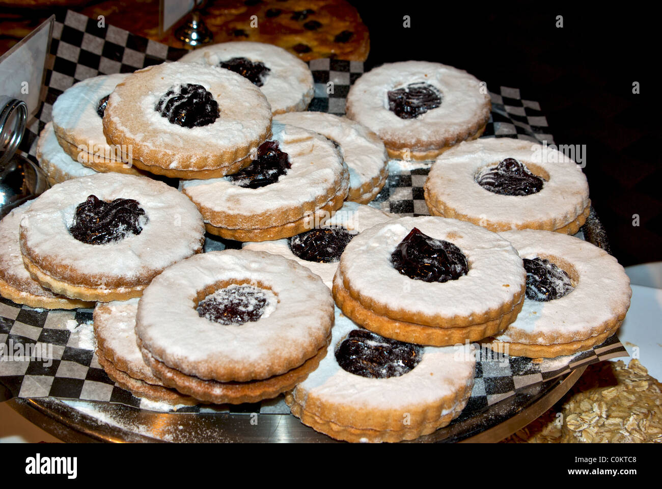 sugar dusted raspberry jam filled cookies piled on platter bakery
