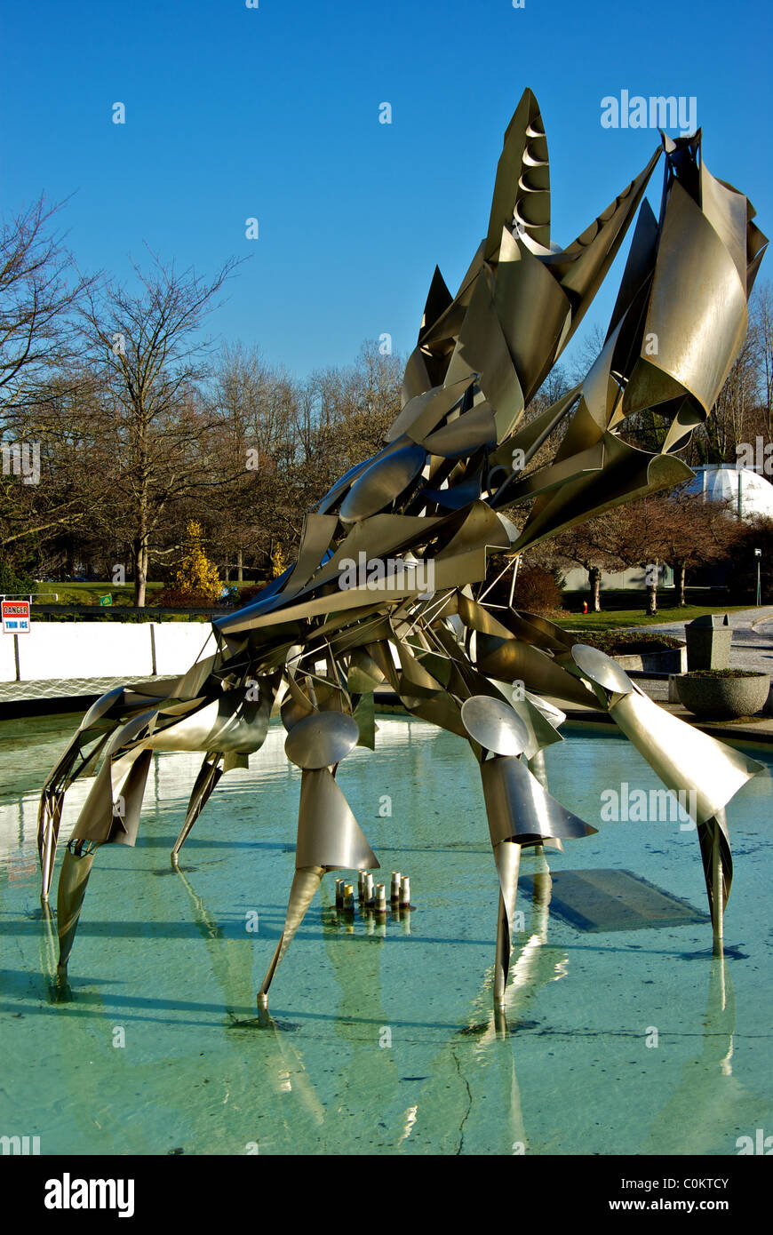 George Norris stainless steel crab sculpture in pool in front of Vancouver HR McMillan Planetarium Stock Photo