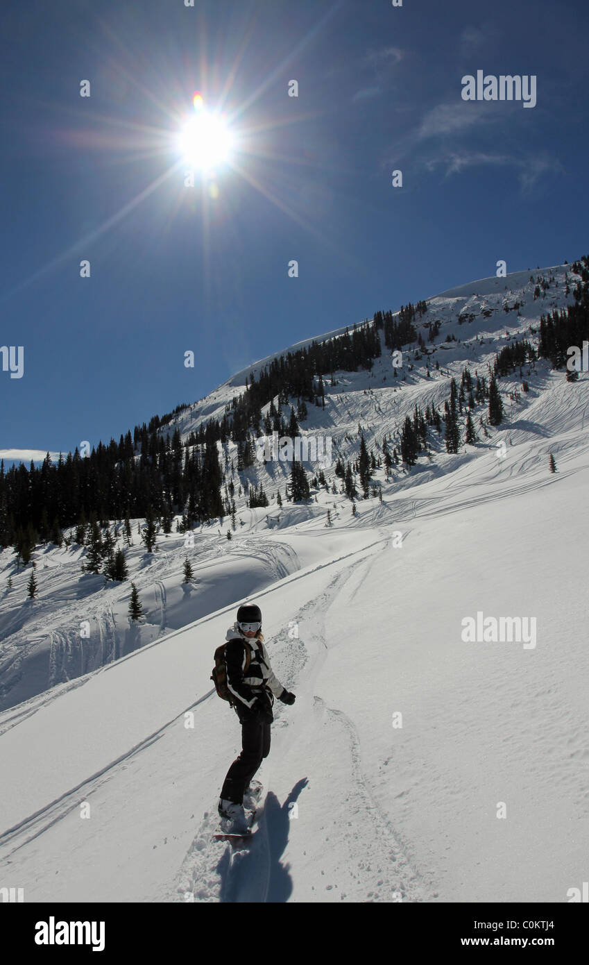 Young woman snowboarding in Vail, Colorado Stock Photo