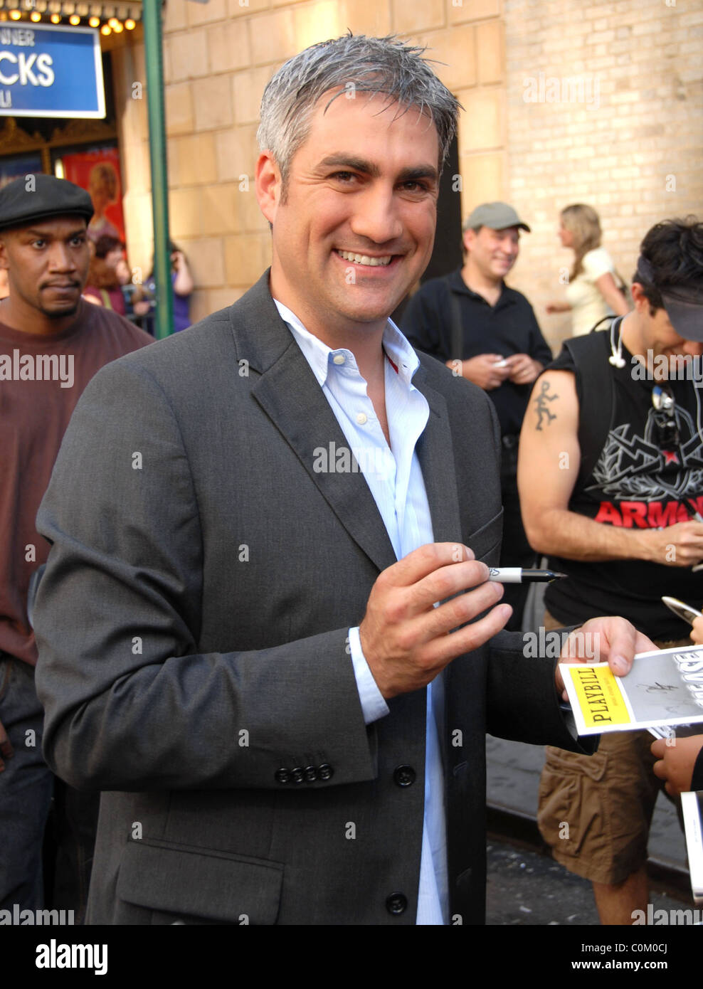 Taylor Hicks signs autographs for fans following his performance in the