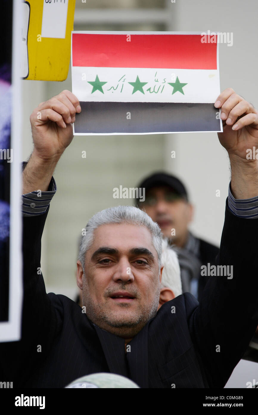 Protester holds up national emblem of Iraq Stock Photo