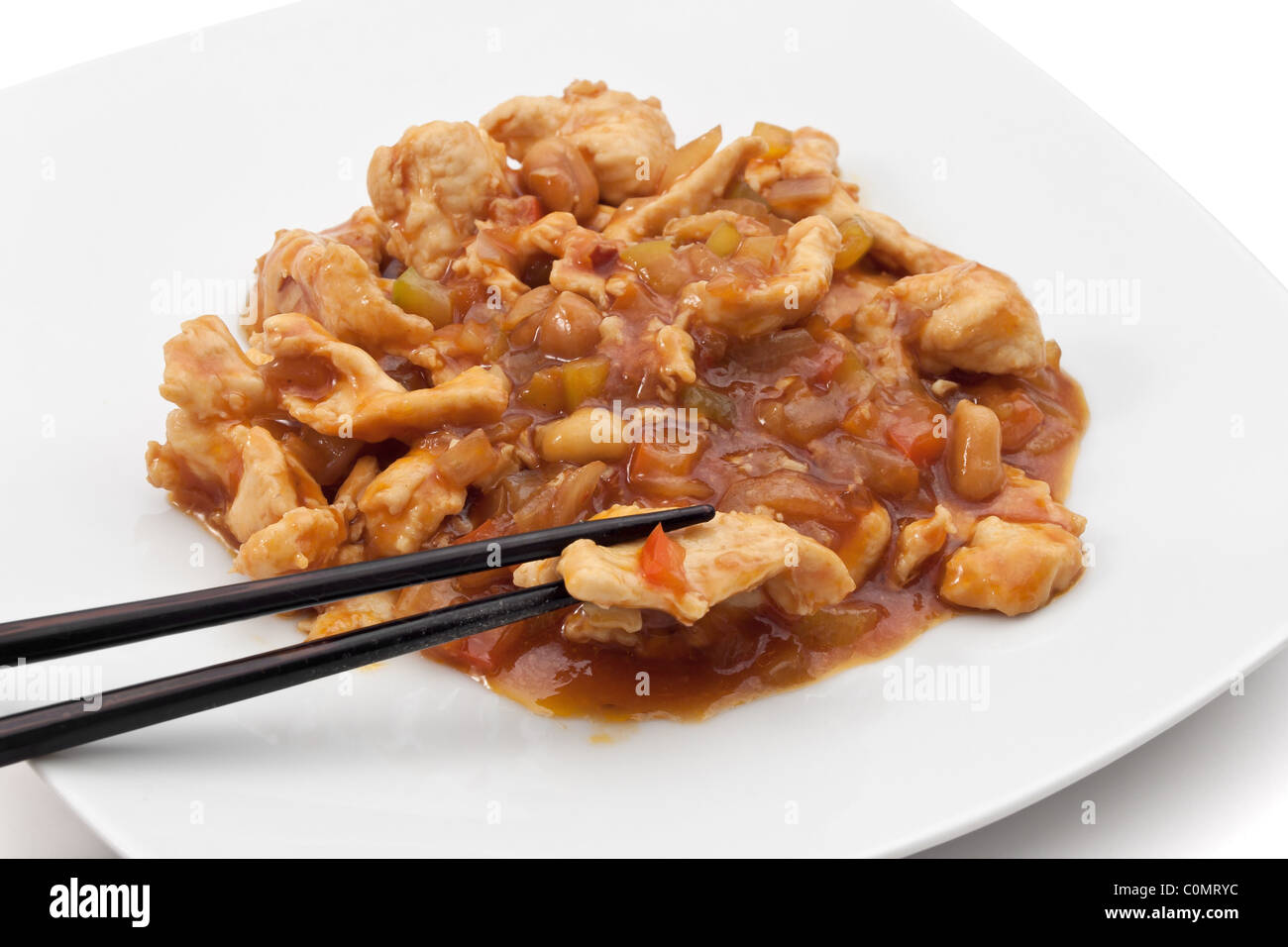 plate with chicken in hot sauce isolated on white background with clipping path Stock Photo