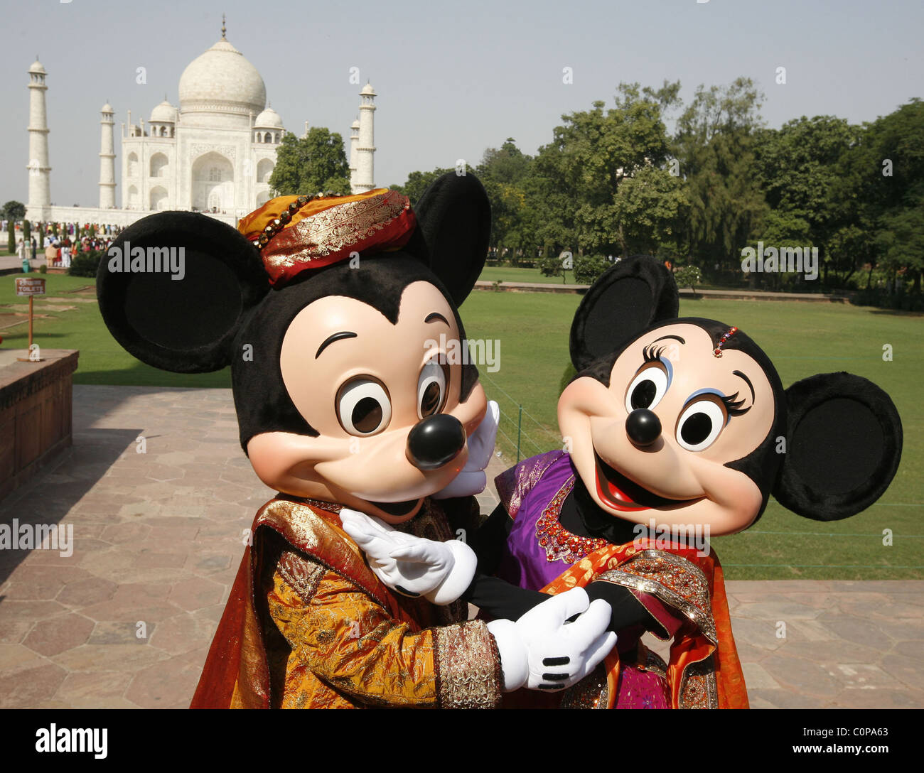 Mickey Mouse and Minnie Mouse pose at the Taj Mahal in Agra, India. The