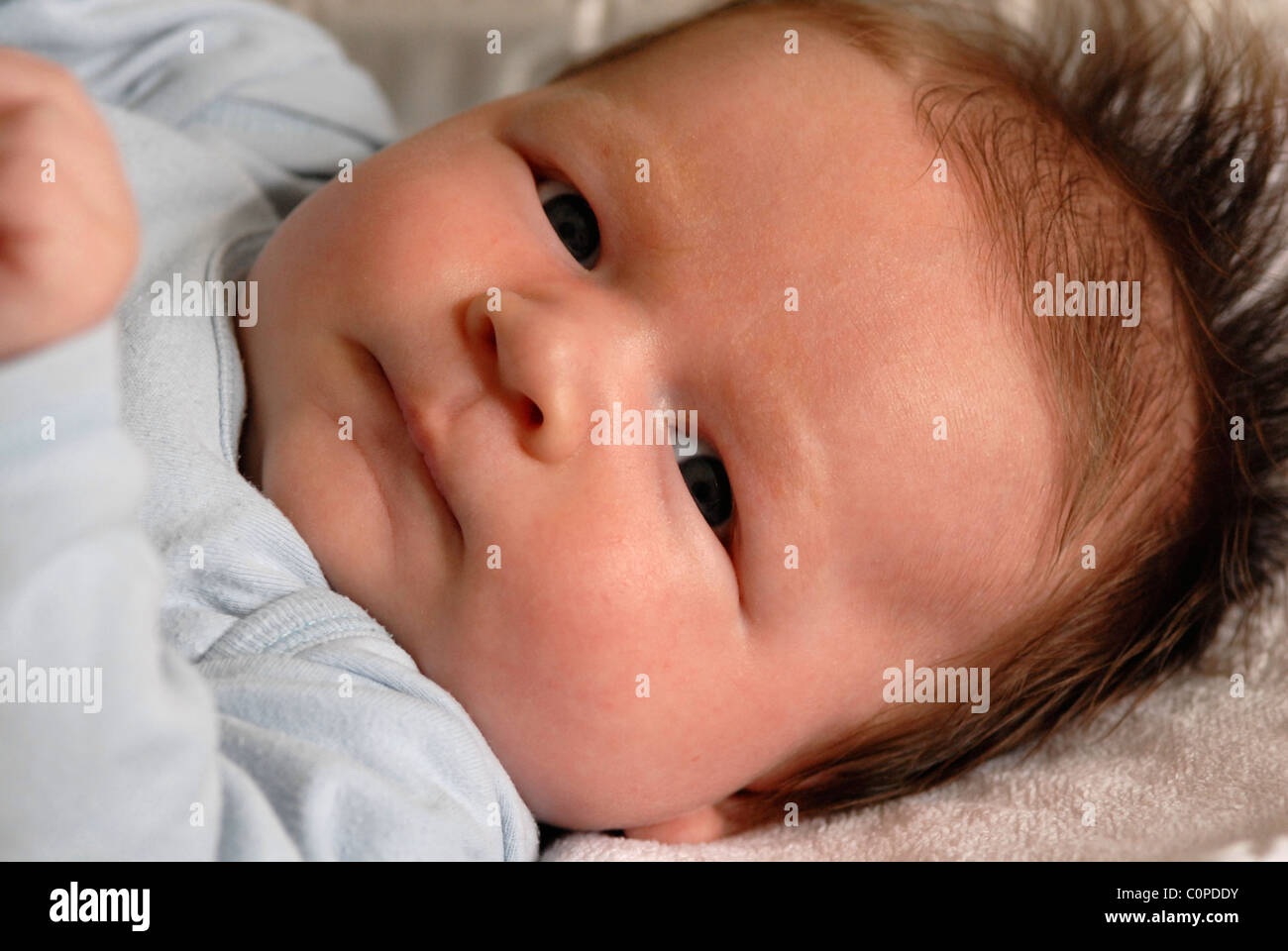Head shot of a baby lying in a cot Stock Photo Alamy