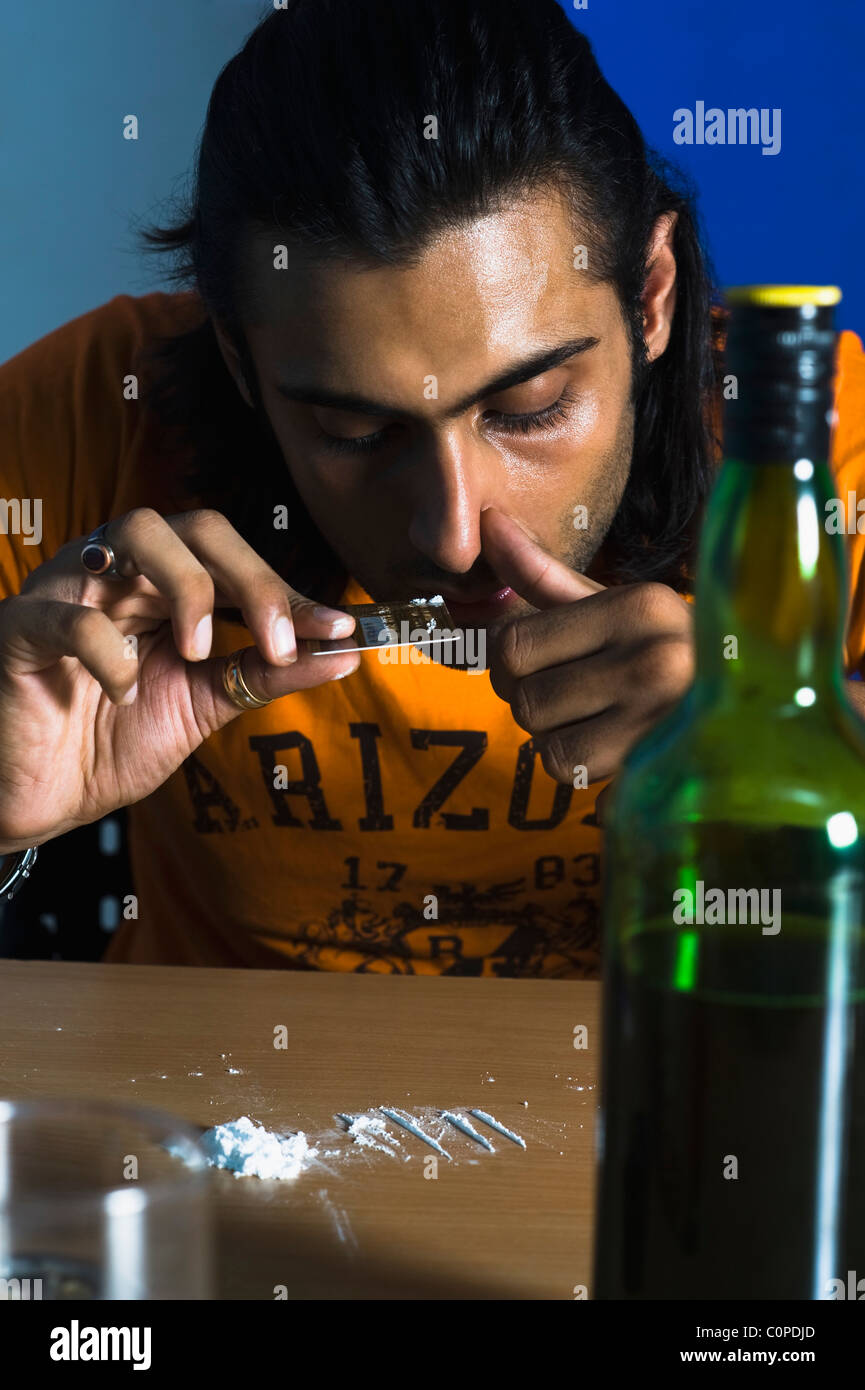 Close-up of a man snorting cocaine Stock Photo